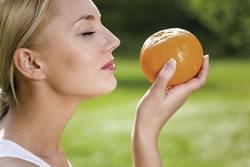 mulher cheirar laranja